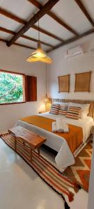 卡拉伊瓦Afeto Caraíva的一间卧室配有一张大床和一张桌子