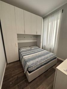 阿拉西奥Nuovo Appartamento Borgo Coscia的一间小卧室,配有床和窗户