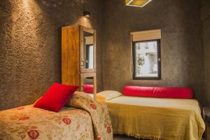 Los ÁrbolesFinca La Pichona的一间客房配有两张带红色枕头的床。