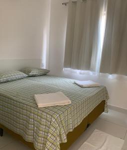 萨尔瓦多VIRASSOL Praia Hotel的一间卧室配有一张床,上面有两条毛巾