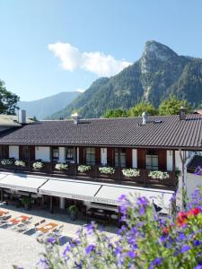 奥巴拉马高s`Wirtshaus Hotel & Restaurant的山间酒店,以鲜花为背景