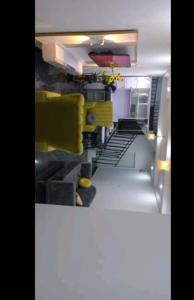GwarinpaMega Pavilion Apartment And Suits Gwarinpa的一间带黄色椅子和楼梯的腿部厨房