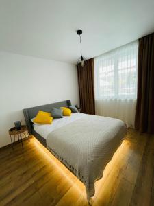 托普利察MAT Apart的一间卧室配有一张带黄色枕头的大床