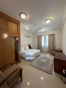 塞拉莱بيت السلطانة للأجنحة الفندقية的配有一张床和一张书桌的酒店客房