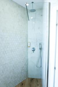都拉斯COSMO Beach Hotel的浴室里设有玻璃门淋浴