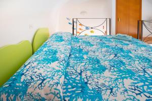 切塔拉Casa vacanze "Il Baffo e il Mare"的床上有蓝色的被子