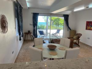 布韦朱Mjanaheri Beach Villas的一间带桌椅和窗户的用餐室