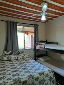穆里基镇Casa Costa Verde-Muriqui的一间卧室设有两张双层床和吊扇