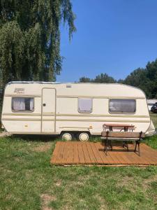 姆热日诺Camping Rogowo的停泊在野餐桌的野外的露营车