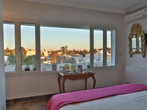 拉马萨达尔苏阿德旅馆的卧室配有床、桌子和窗户。