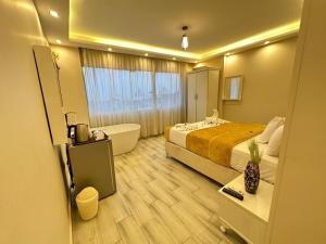 Kafret el-GabalHappy pyramids view的酒店客房配有一张床和浴缸。