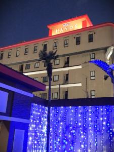 Ginanホテルハンズ的建筑前有蓝色灯光的酒店