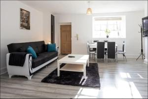 伯肯黑德Devonshire Road - Apartment 1的客厅配有沙发和桌子