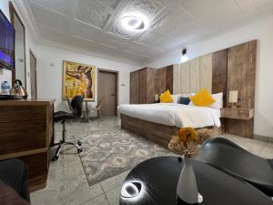 阿布贾UrbaN RootZ的配有一张床和一张书桌的酒店客房
