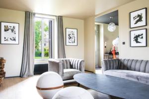 Vendeuvre-du-PoitouLes Olympiades - Magnifique Villa d'évasion的客厅配有沙发、椅子和桌子