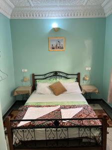 穆莱伊德里斯蒂亚尔迪美酒店的一间卧室配有一张蓝色墙壁的床
