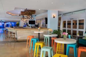 迈阿密海滩Stunning Getaway with Private Outdoor Roman Tub的餐厅设有色彩缤纷的桌子和凳子