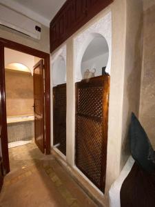马拉喀什Riad Dar Teranga Hotel & Spa的走廊上设有门的房间和带淋浴的房间