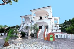 佩斯基奇Villa Ialillo的白色的房子,设有楼梯和游乐场