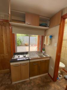 奥索尔诺Arriendo de cabaña centro osorno的小厨房配有炉灶和水槽
