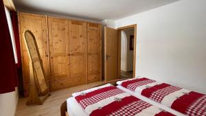 克洛斯特斯Ferienwohnung mit idyllischer Aussicht的一间卧室配有一张床和木制橱柜
