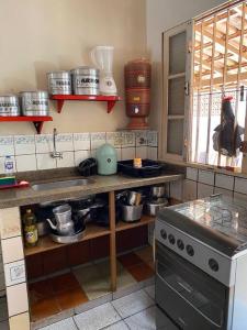 皮乌马Casa com terraço em Piúma.的厨房配有水槽和带锅碗瓢盆的台面