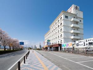 笛吹市Tabist Hotel Sun Plaza Fuefuki Isawa的大楼前空的街道