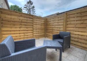 蒙塔日Eden Garden climatisé avec une terrasse的庭院设有两把椅子、一张桌子和围栏