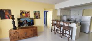 Ban ChamrungVIP Condochain Rayong的一个带小岛的厨房,厨房内配有电视