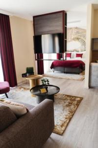 塞格德RIVA Boutique Hotel的客厅配有沙发和1张床