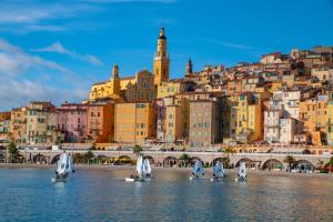 芒通Hôtel Vendôme Menton - Reouverture的一群帆船在水中,在城市前方