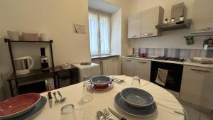 安科纳Ankon Apartment La Casa di Joye & Nemi的厨房配有带盘子的桌子