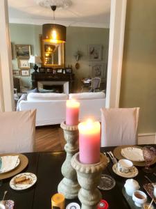 布鲁瓦圣路易斯16号住宿加早餐旅馆的一间餐桌上的带两个蜡烛的用餐室