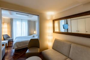 卢塞恩德天平酒店的酒店客房,配有床和镜子