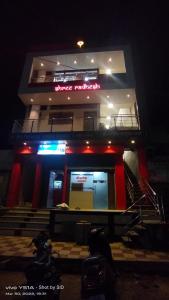 潘达尔普尔Shree Radhesh Bhakt Niwas的一间晚上有商店前的建筑