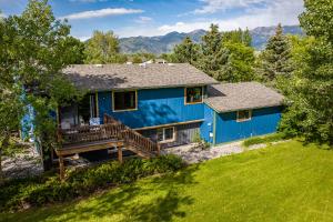 博兹曼Mountain Escape: with Sauna near Yellowstone的蓝色的房子,设有甲板,背景是群山