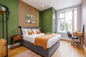 伯恩茅斯Sea Breeze - Coast的一间卧室设有一张带绿色墙壁的大床