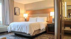 皮奥里亚大草原城皮奥里亚洲际酒店&度假村，烛木套房酒店的酒店客房配有带白色床单和枕头的床。
