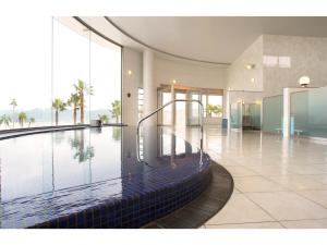 天草市Hotel Alegria Gardens Amakusa - Vacation STAY 40453v的一座大型游泳池,位于一座带大窗户的建筑内