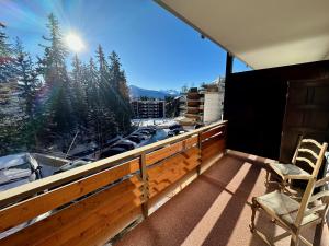 克莱恩 蒙塔纳Studio Serenity, 4 min walk to ski!的阳台配有两把椅子,享有停车场的景致。