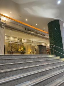 马尼拉Makati Palace Hotel的市场酒店前的一座带楼梯的建筑