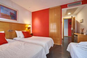 伊列斯卡斯里尔德依莱斯卡酒店的酒店客房设有两张床和红色的墙壁。