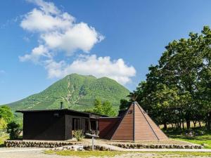 由布市Sense of wonder Yufudake Sanroku Glamping Resort - Vacation STAY 41961v的一座小房子,后面有山