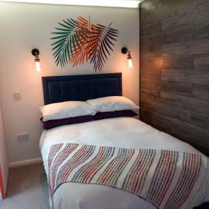 Thistles -Private Entrance Studio的一间卧室配有一张大床和木制床头板