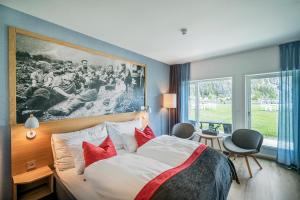 瓦尔河谷Valldal Fjordhotell - by Classic Norway Hotels的酒店客房配有一张带红色枕头的大床