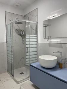 蒙多维Le Ghie的一间带玻璃淋浴和水槽的浴室