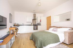 红山Queens Lodge 1-Bed Apartment in Redhill的一间带床和厨房的客厅