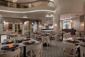 卢克索Steigenberger Nile Palace Luxor - Convention Center的用餐室配有桌子和白色椅子