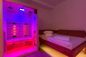 马里博尔Vilaraj的配有床和粉红色的LED灯的房间