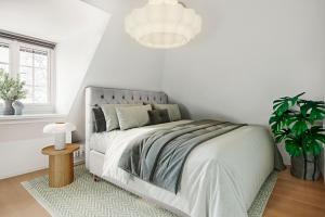 斯德哥尔摩Central beautiful modern accommodation near Stockholm City的一间白色的卧室,配有床和盆栽植物